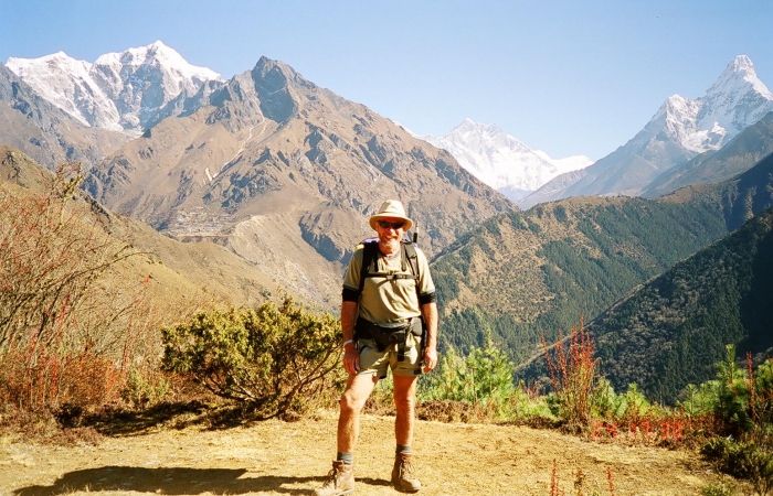 A trekker poses on a rare bit of level ground